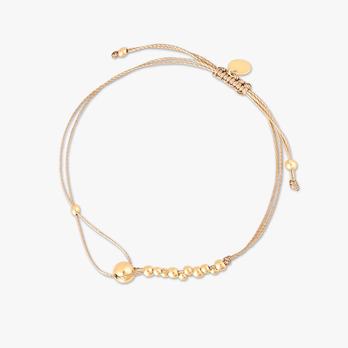 Bransoletka na beżowym sznurku